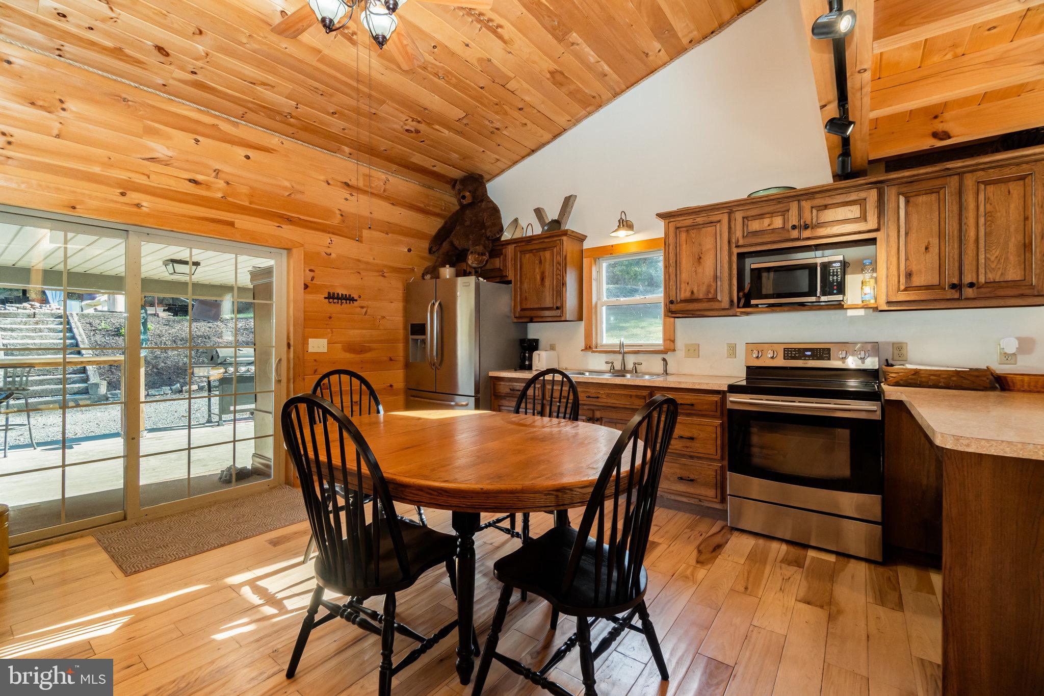 1180 Campbell Hollow Road East Waterford, PA 17021 - Photo 6 of 51 a view of a dining room with furniture and wooden floor