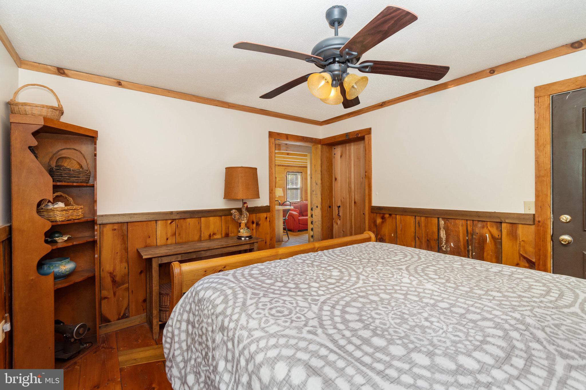 1180 Campbell Hollow Road East Waterford, PA 17021 - Photo 9 of 51 a bedroom with a bed and a chandelier