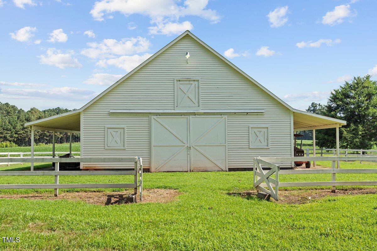 206 Shaver Road Macon, NC 27551 - Photo 56 of 68 a front view of a house with a yard and garage
