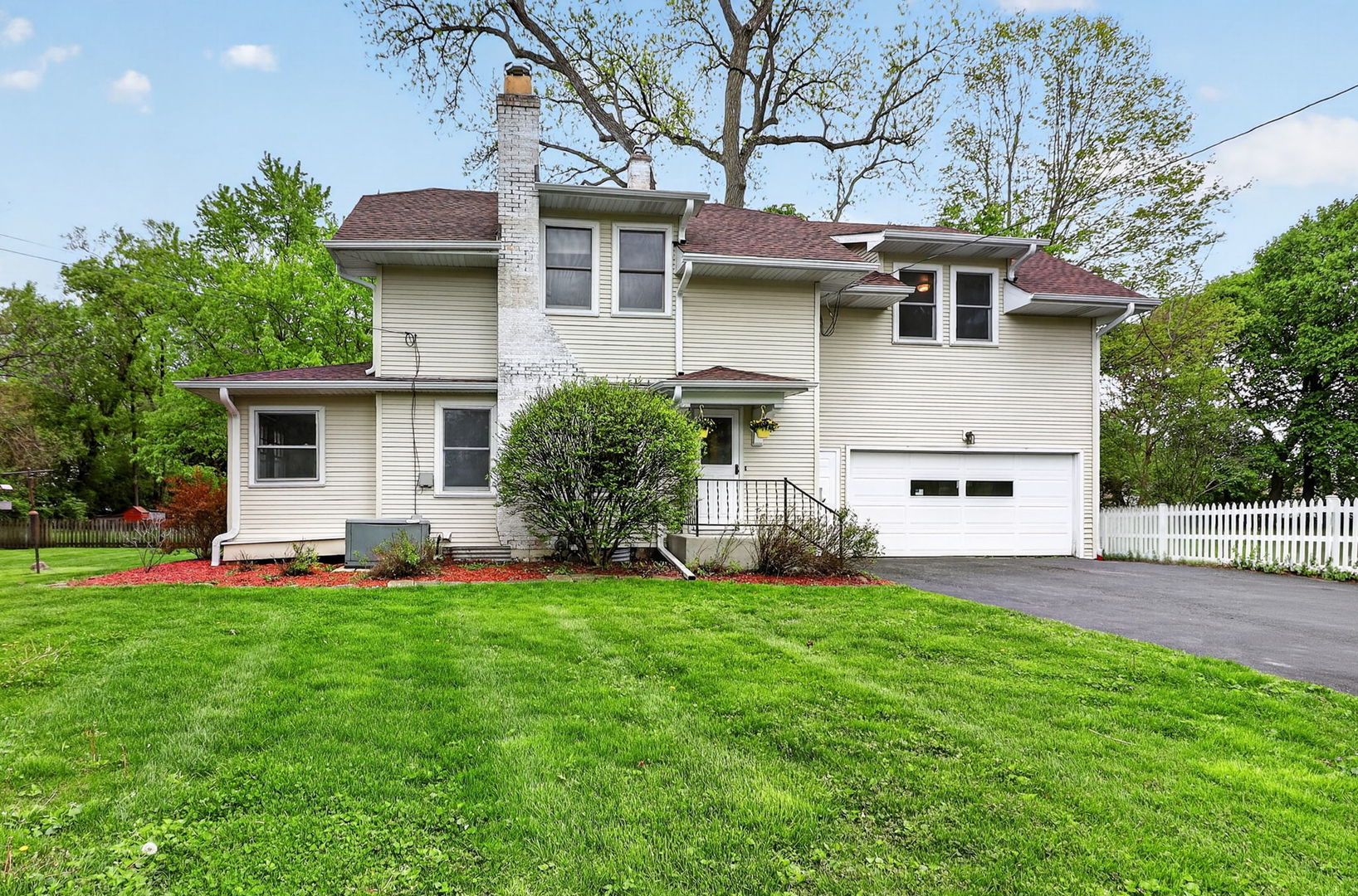a view of a house with a yard and sitting area