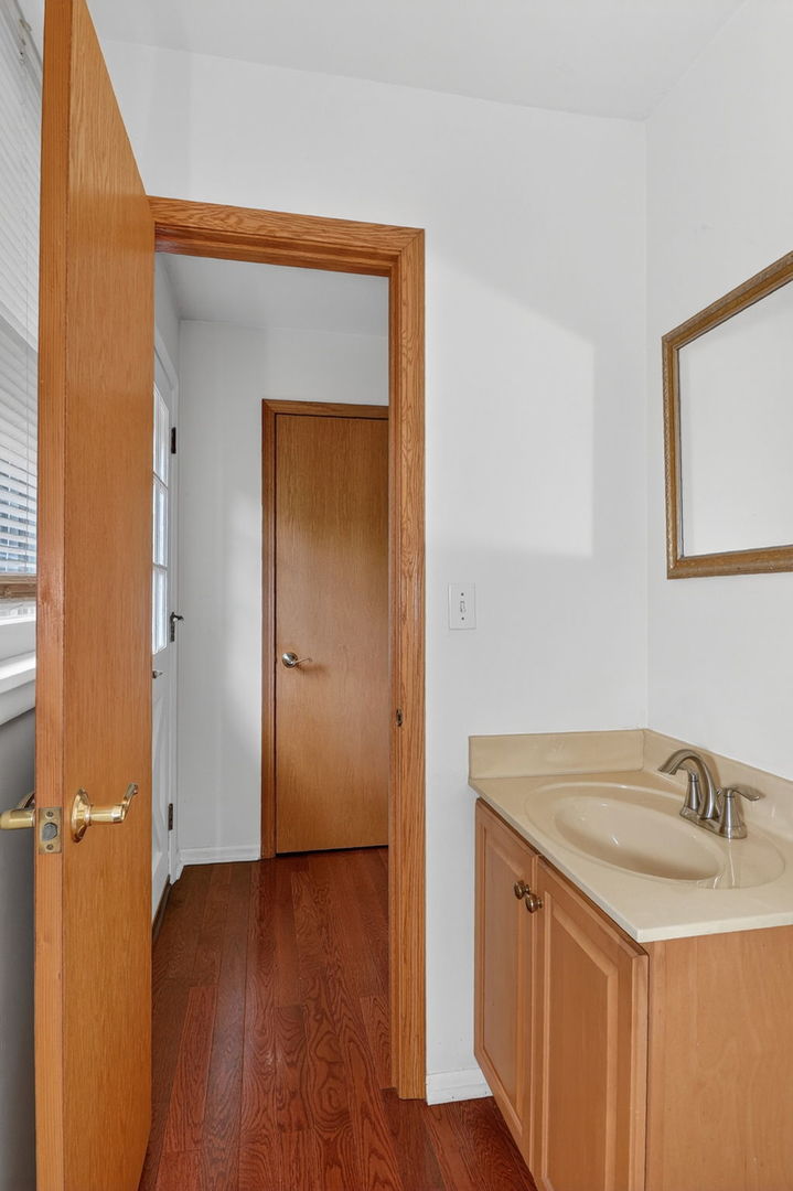 32W183 Glos Street Wayne, IL 60184 - Photo 12 of 30 a bathroom with a sink and a mirror