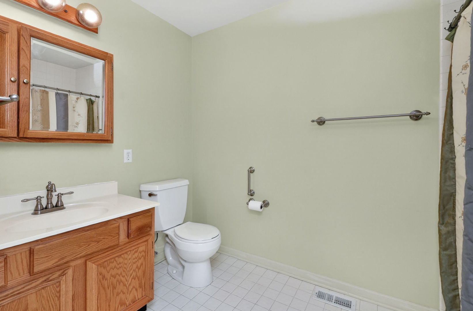 32W183 Glos Street Wayne, IL 60184 - Photo 15 of 30 a white toilet sitting next to a bathroom sink