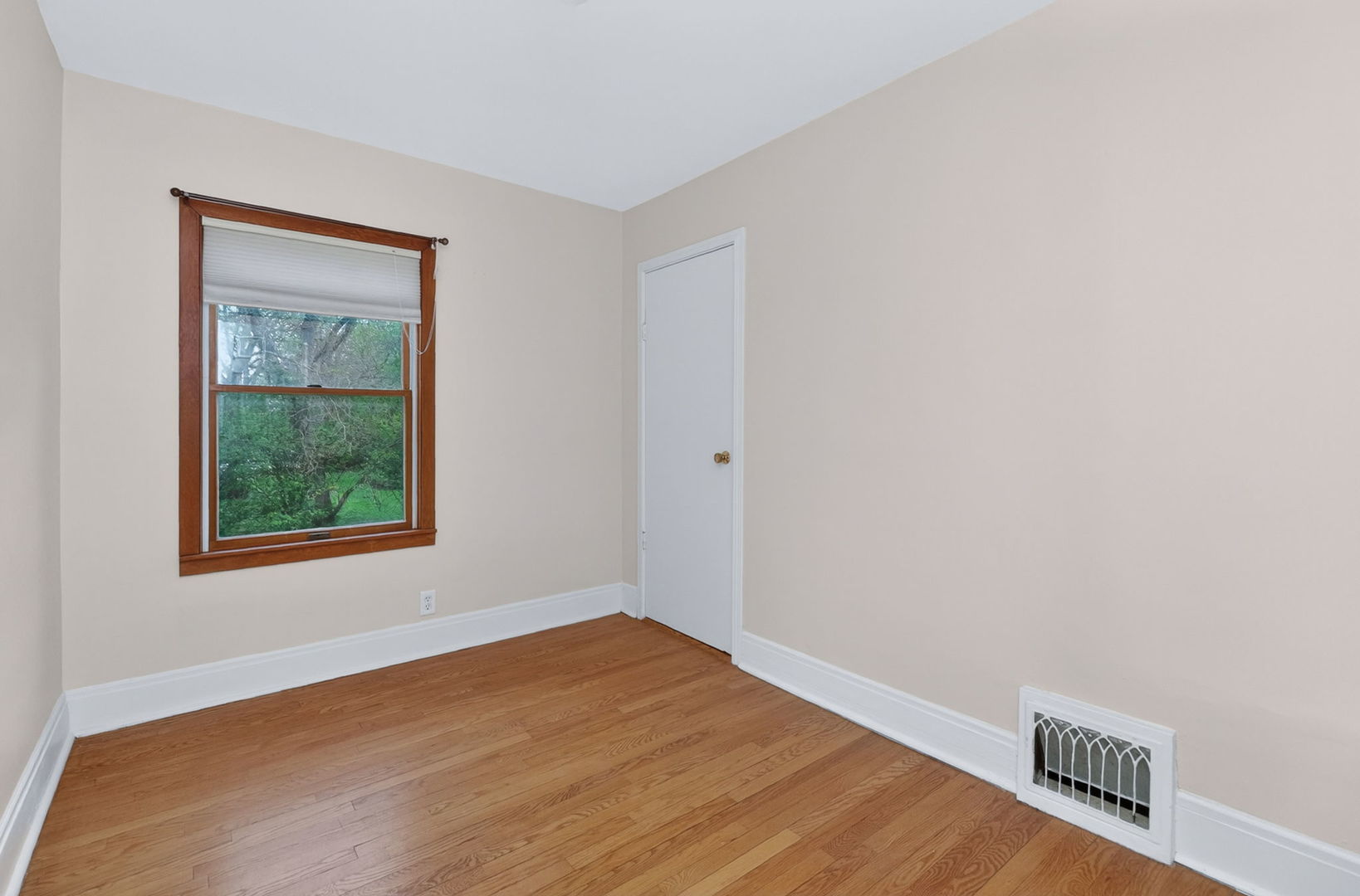 32W183 Glos Street Wayne, IL 60184 - Photo 18 of 30 a view of an empty room with wooden floor and a window