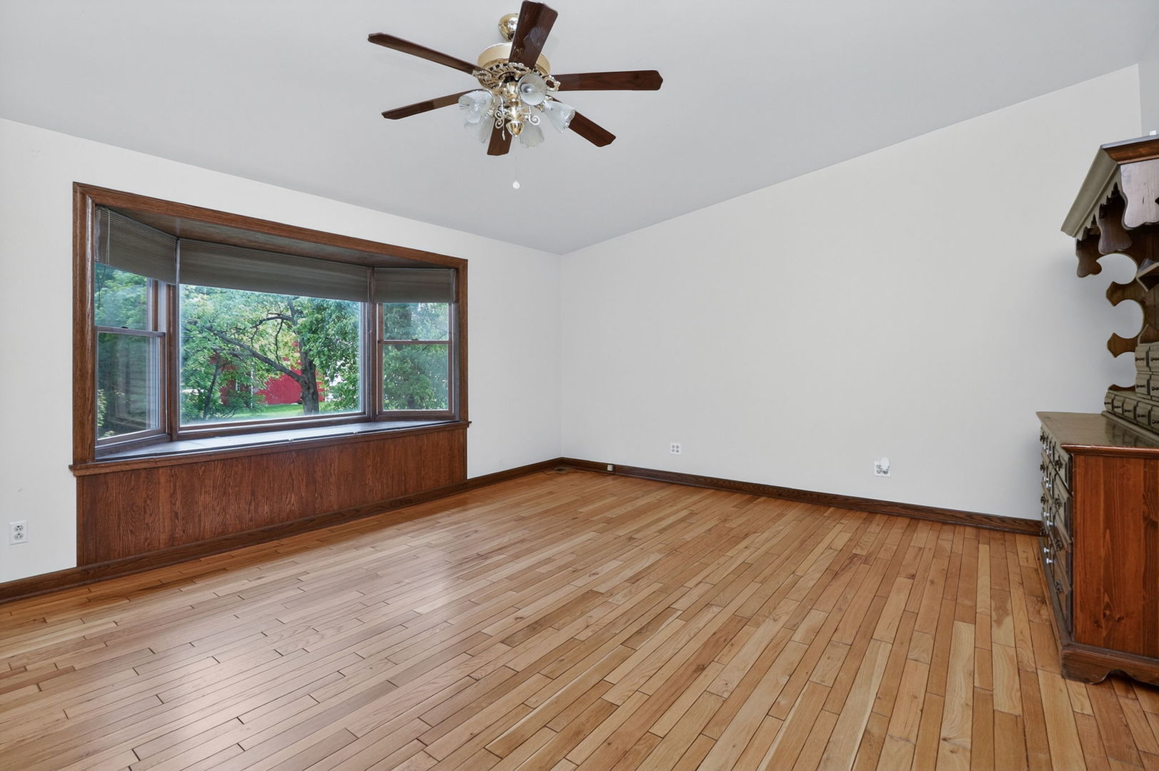 32W183 Glos Street Wayne, IL 60184 - Photo 21 of 30 an empty room with wooden floor fan and windows