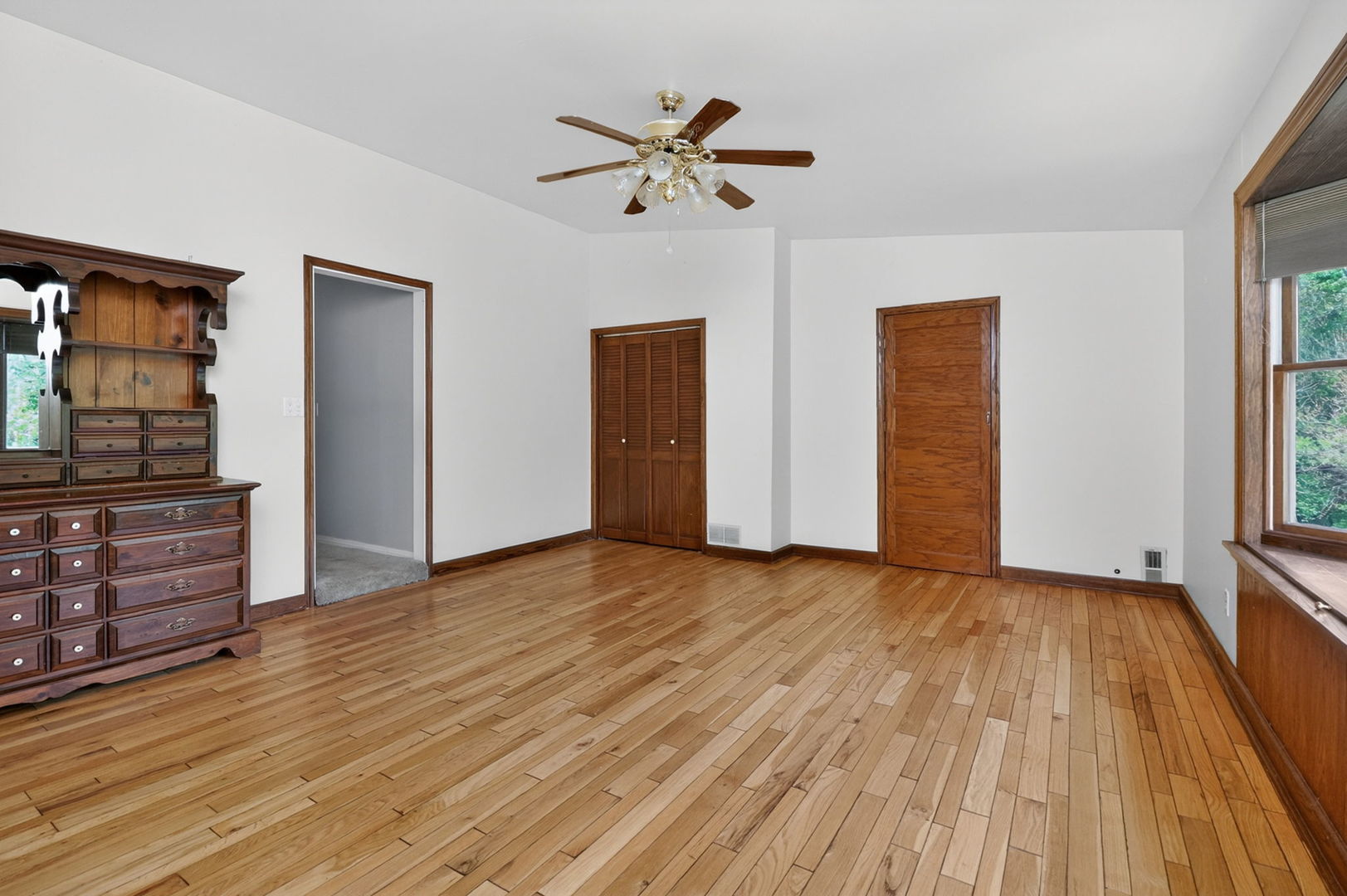 32W183 Glos Street Wayne, IL 60184 - Photo 22 of 30 wooden floor in an empty room with a window