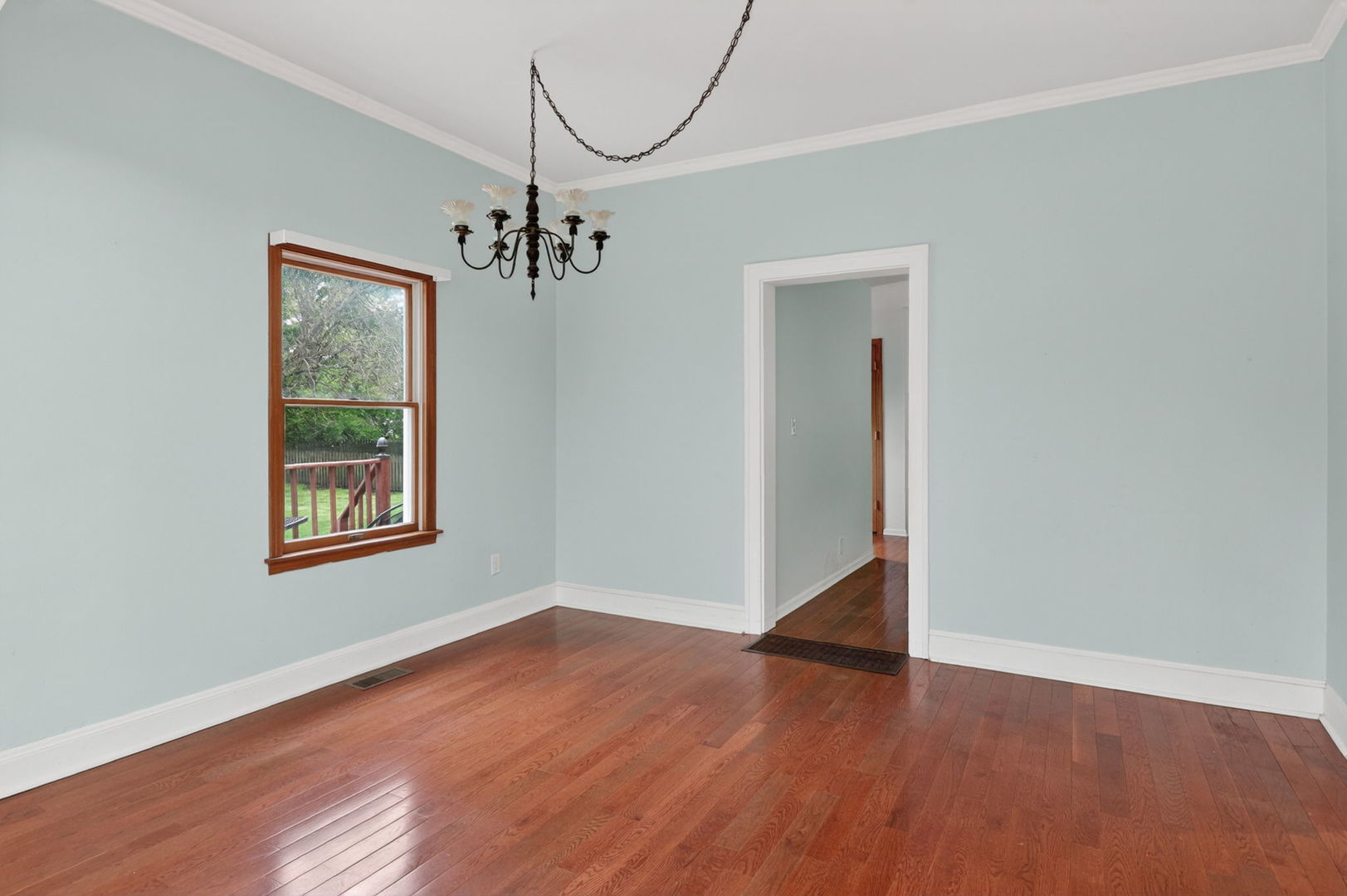 32W183 Glos Street Wayne, IL 60184 - Photo 5 of 30 a view of an empty room with wooden floor and a window
