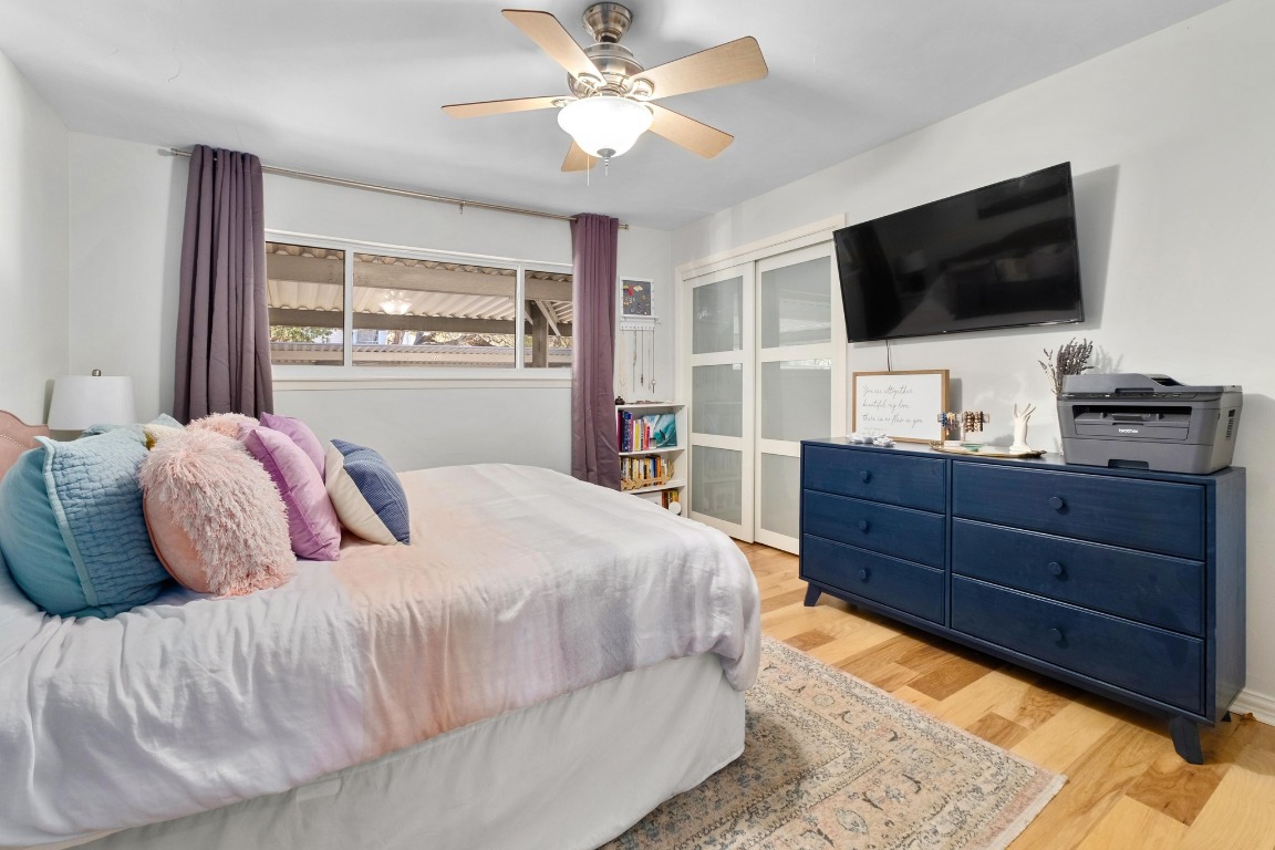 1210 Windsor Road, Unit 122 Austin, TX 78703 - Photo 19 of 24 Bedroom featuring light wood finished floors and ceiling fan