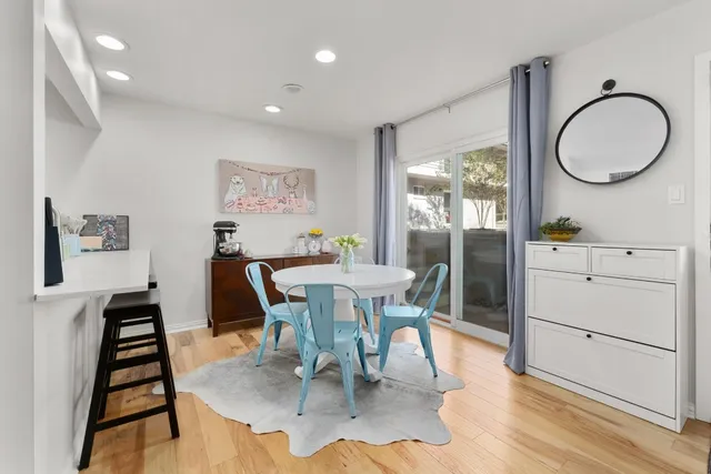 a view of a dining room with furniture and a window