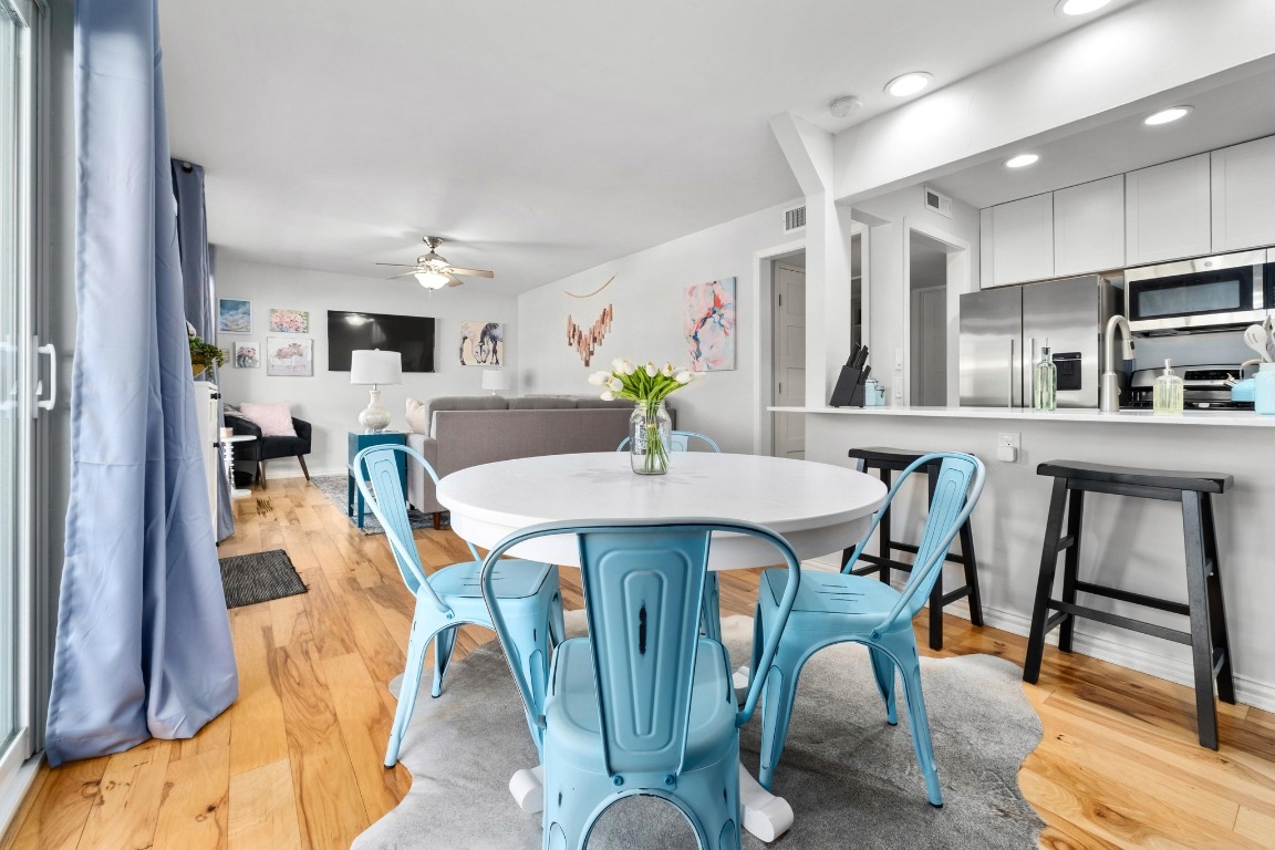 1210 Windsor Road, Unit 122 Austin, TX 78703 - Photo 9 of 24 Dining space featuring a ceiling fan and light wood-style flooring