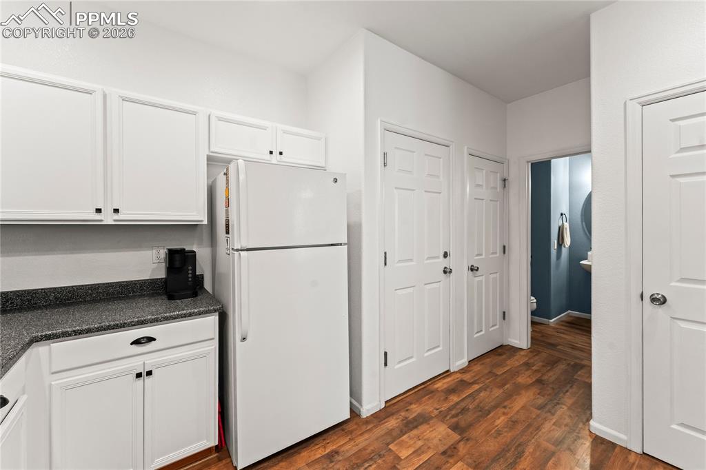 7362 Sandy Springs Point Fountain, CO 80817 - Photo 14 of 41 a kitchen with a refrigerator and cabinets