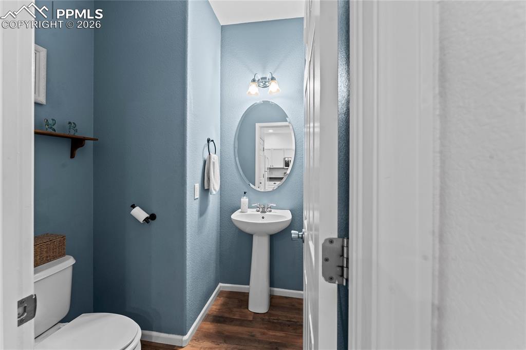 7362 Sandy Springs Point Fountain, CO 80817 - Photo 16 of 41 a bathroom with a toilet a sink and mirror