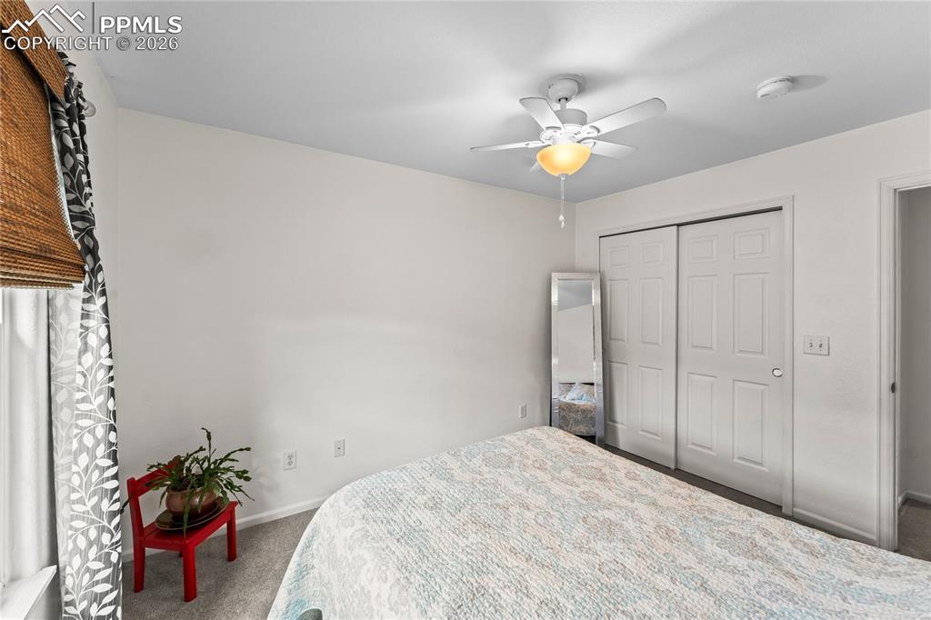 7362 Sandy Springs Point Fountain, CO 80817 - Photo 23 of 41 a bedroom with a bed and a chandelier