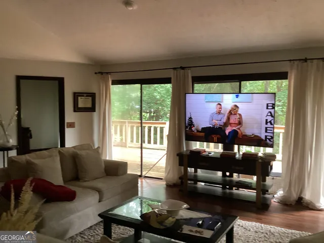a living room with furniture and a floor to ceiling window