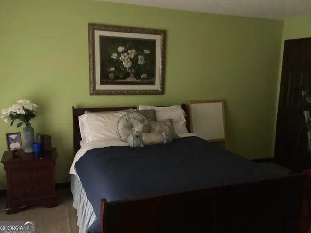 a bed sitting in a bedroom next to a small yard