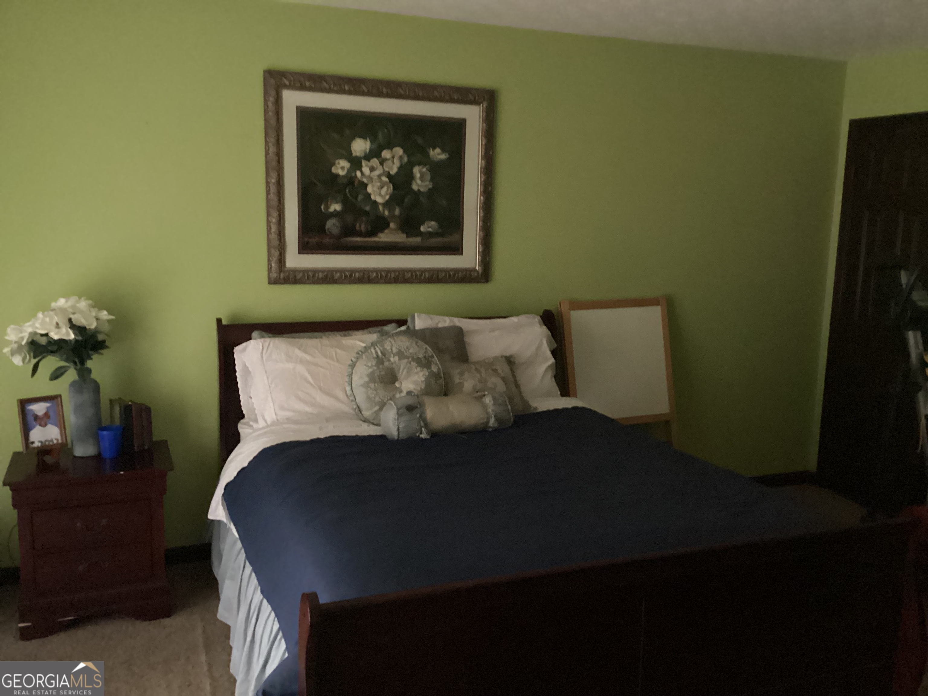 1497 Stonington Court Villa Rica, GA 30180 - Photo 5 of 10 a bed sitting in a bedroom next to a small yard