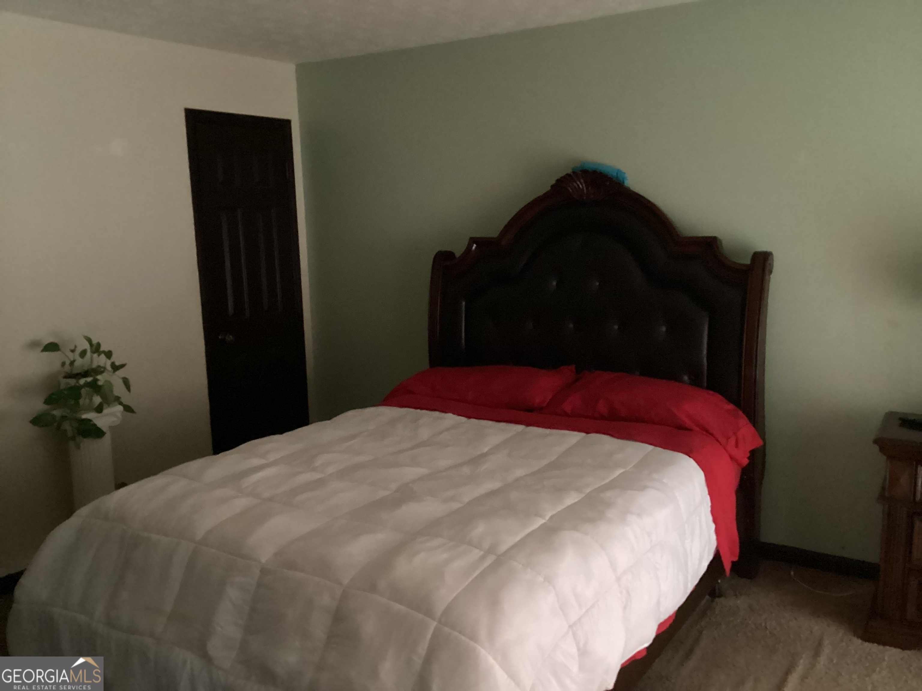 1497 Stonington Court Villa Rica, GA 30180 - Photo 6 of 10 a bedroom with a bed and a potted plant