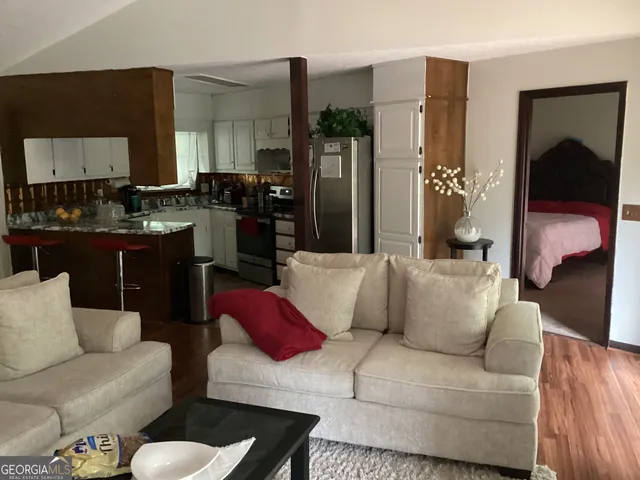 a living room with furniture and a lamp