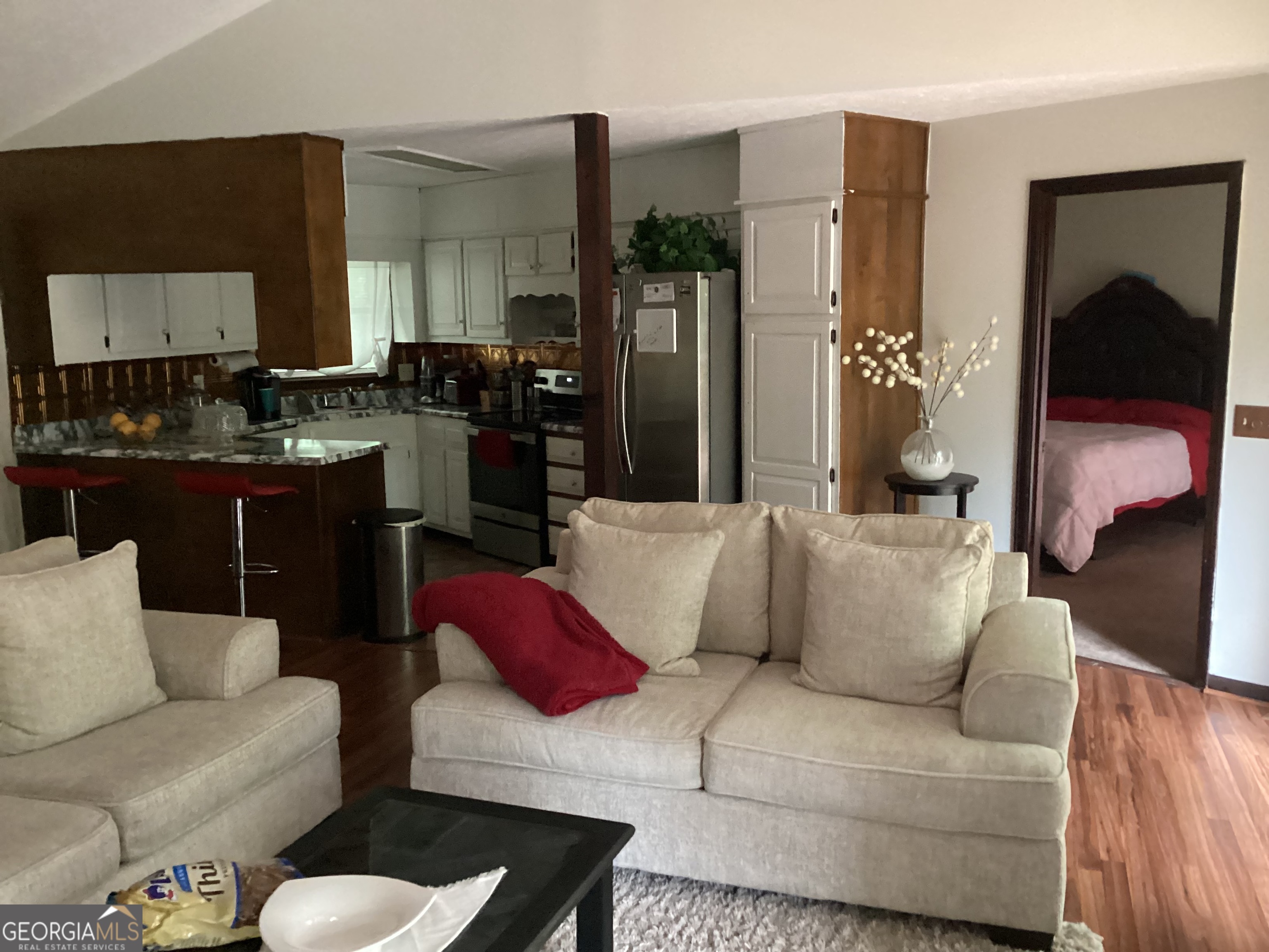 1497 Stonington Court Villa Rica, GA 30180 - Photo 9 of 10 a living room with furniture and a lamp