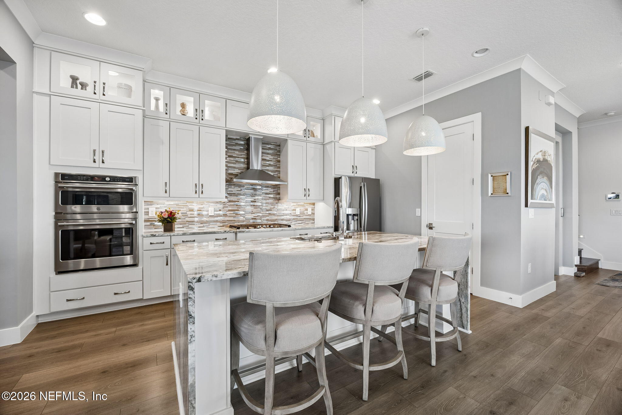 662 Rum Runner Way St. Johns, FL 32259 - Photo 16 of 79 a kitchen with stainless steel appliances kitchen island granite countertop a dining table chairs sink and cabinets