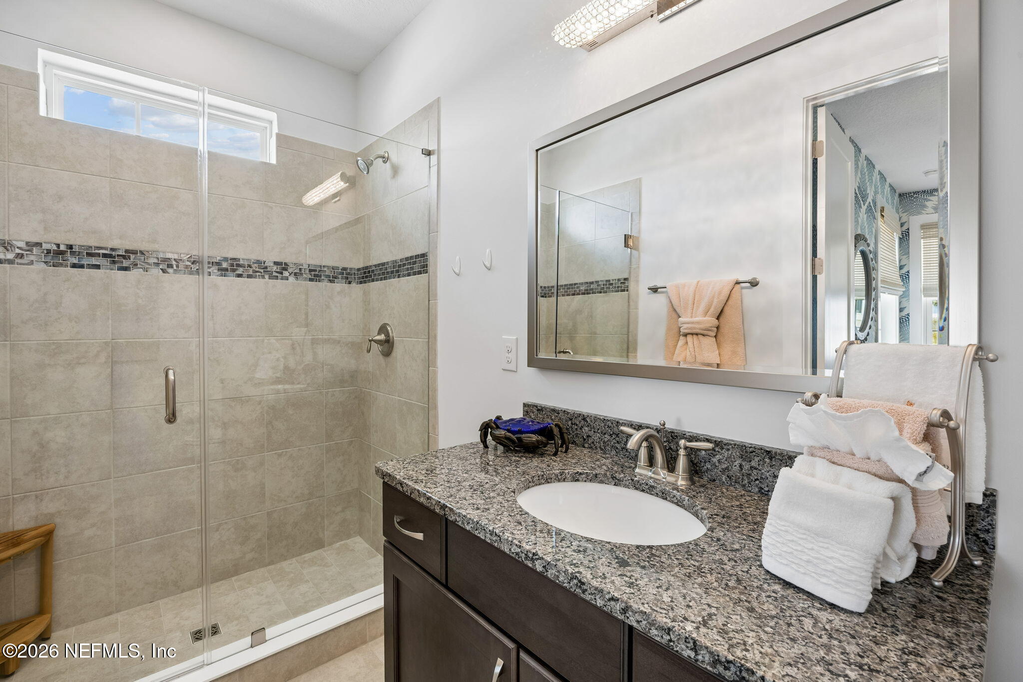 662 Rum Runner Way St. Johns, FL 32259 - Photo 36 of 79 a bathroom with a granite countertop sink a mirror and a shower