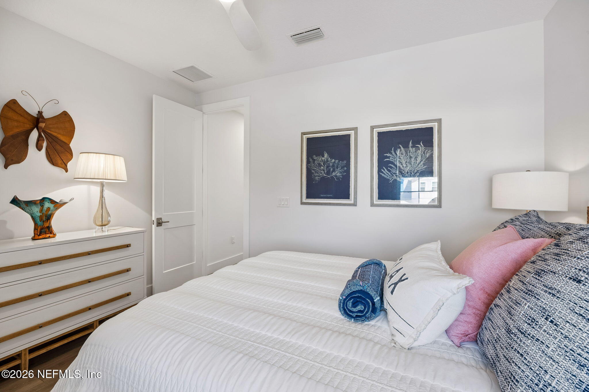 662 Rum Runner Way St. Johns, FL 32259 - Photo 38 of 79 a bedroom with a bed and a lamp on dresser