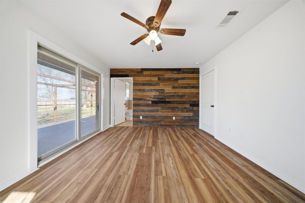 697 County Road 166 Whitesboro, TX 76273 - Photo 11 of 32 wooden floor in an empty room with a window