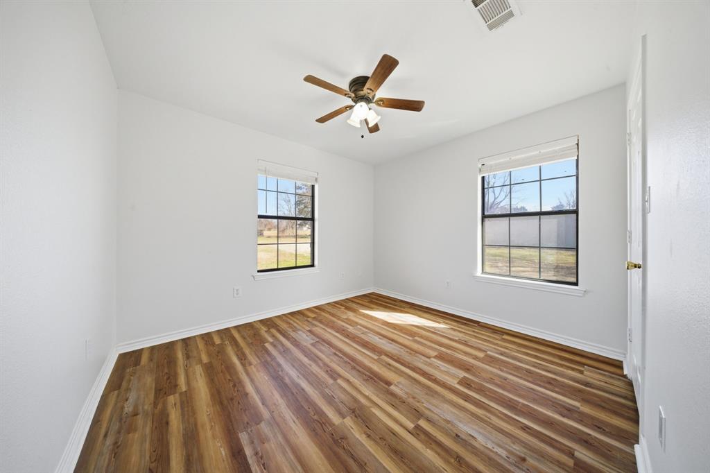 697 County Road 166 Whitesboro, TX 76273 - Photo 15 of 32 wooden floor in an empty room with a window