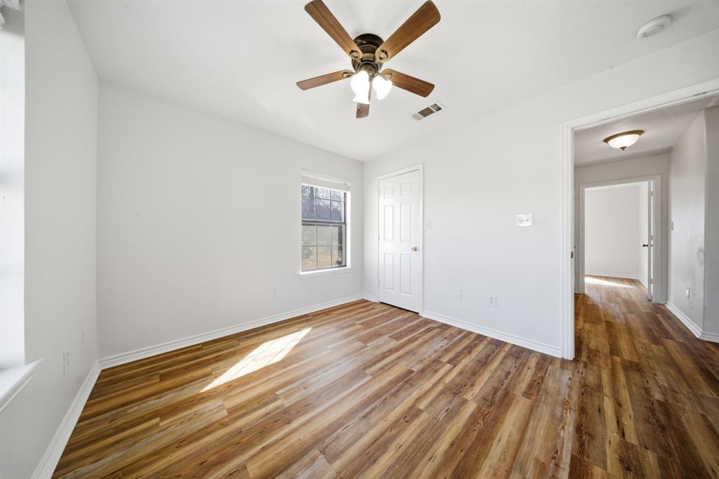 697 County Road 166 Whitesboro, TX 76273 - Photo 16 of 32 wooden floor in an empty room with a window