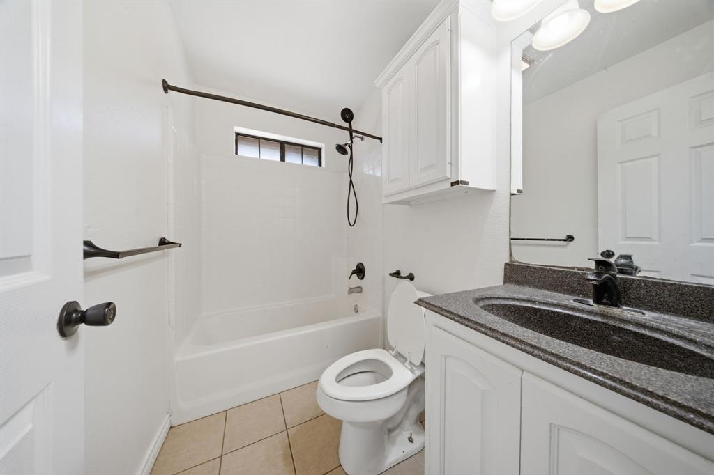 697 County Road 166 Whitesboro, TX 76273 - Photo 18 of 32 a bathroom with a sink a toilet and shower