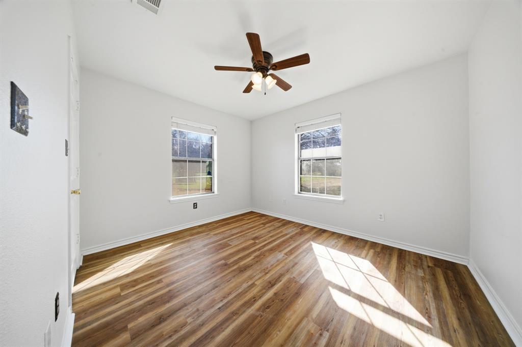 697 County Road 166 Whitesboro, TX 76273 - Photo 19 of 32 a view of empty room with wooden floor and fan