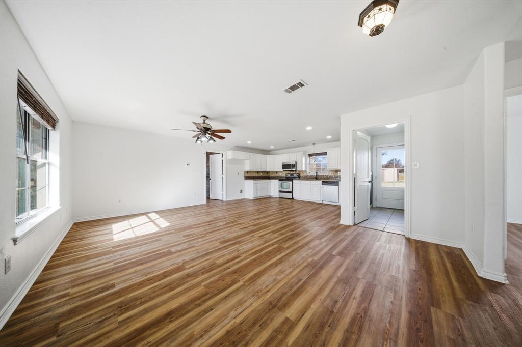 697 County Road 166 Whitesboro, TX 76273 - Photo 5 of 32 wooden floor in an empty room with a window