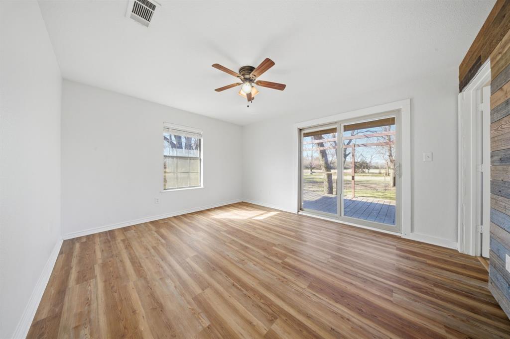 697 County Road 166 Whitesboro, TX 76273 - Photo 10 of 32 a view of empty room with wooden floor and fan