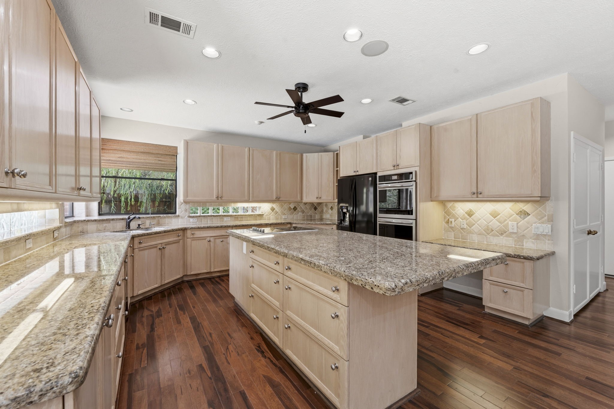 18503 Cabaniss Circle Spring, TX 77379 - Photo 18 of 49 Thoughtfully designed with an open layout, the kitchen stays connected to the breakfast area and family room, making it easy to gather while meals are prepared.