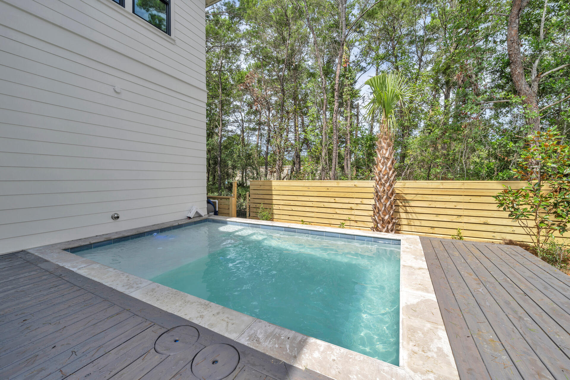 250 Grande Pointe Cir Inlet Beach Inlet Beach, FL 32461 - Photo 24 of 48 a view of a backyard with wooden floor and fence and a floor to ceiling window