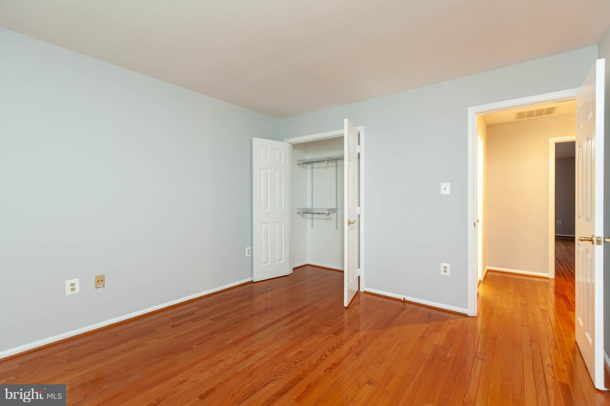 20714 Riptide Square Sterling, VA 20165 - Photo 22 of 30 a view of an empty room with wooden floor