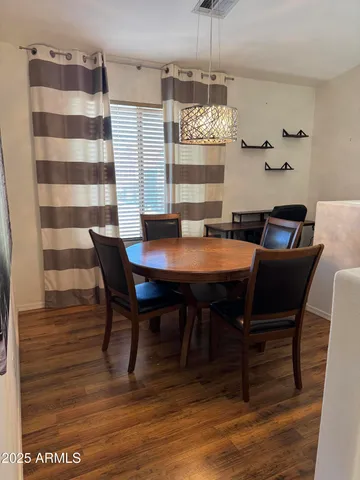 a view of a dining room with furniture and chandelier