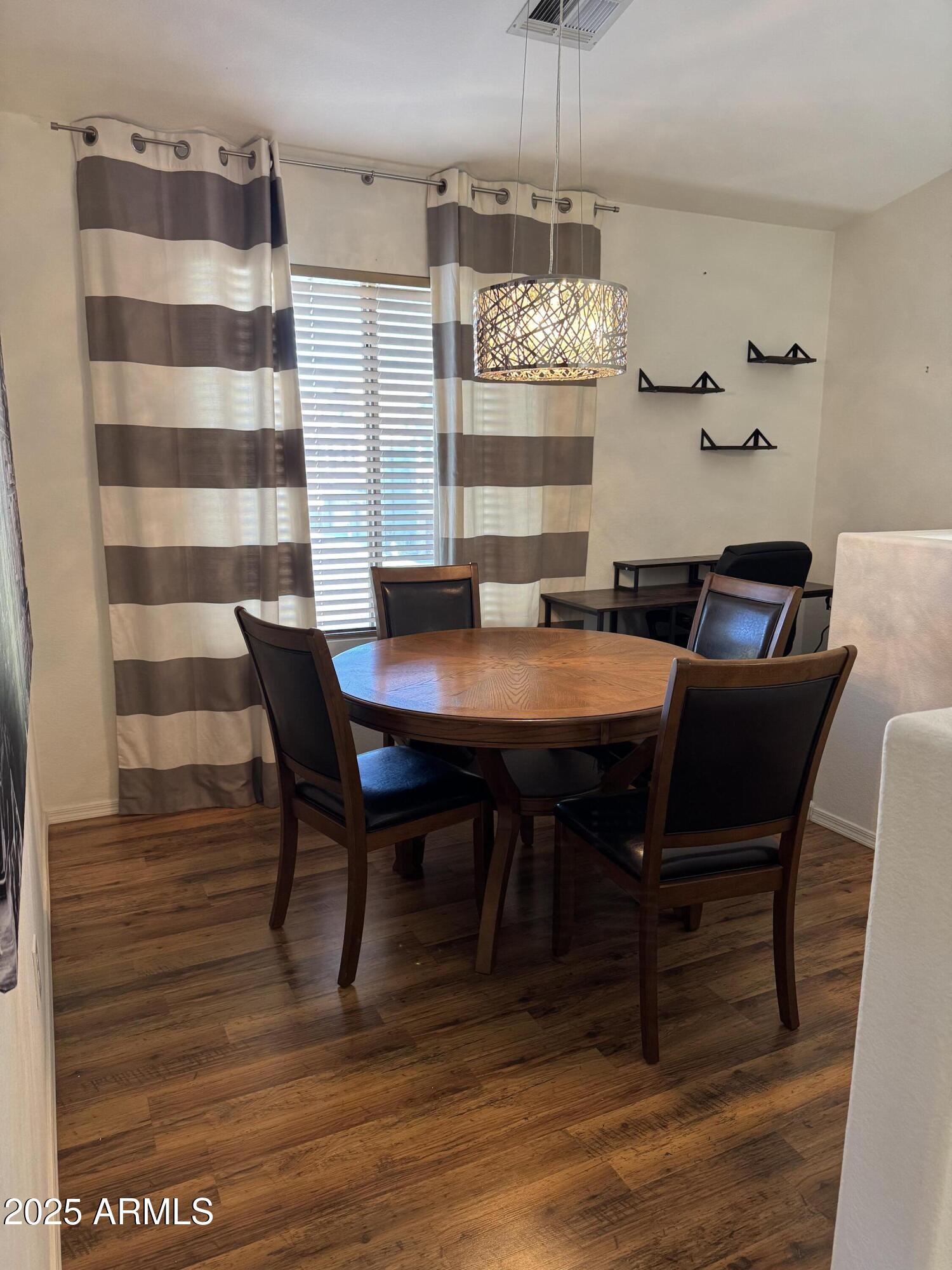 a view of a dining room with furniture and chandelier