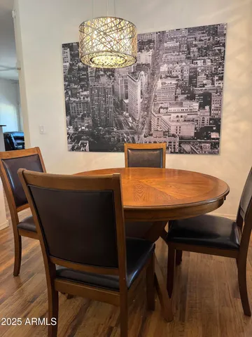 a room with a table chairs and wooden floor