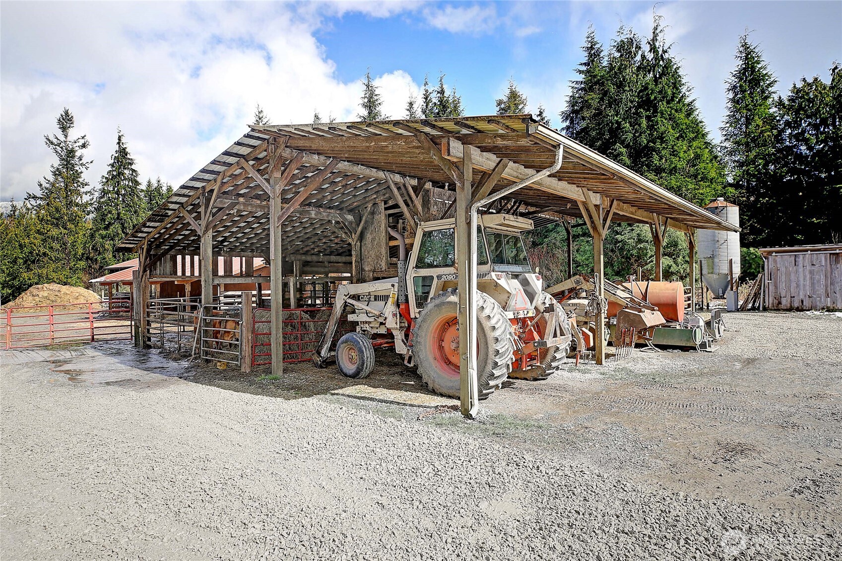 39729 State Rte 530 Northeast Arlington, WA 98223 - Photo 29 of 40 a view of a garage with a bike and white house