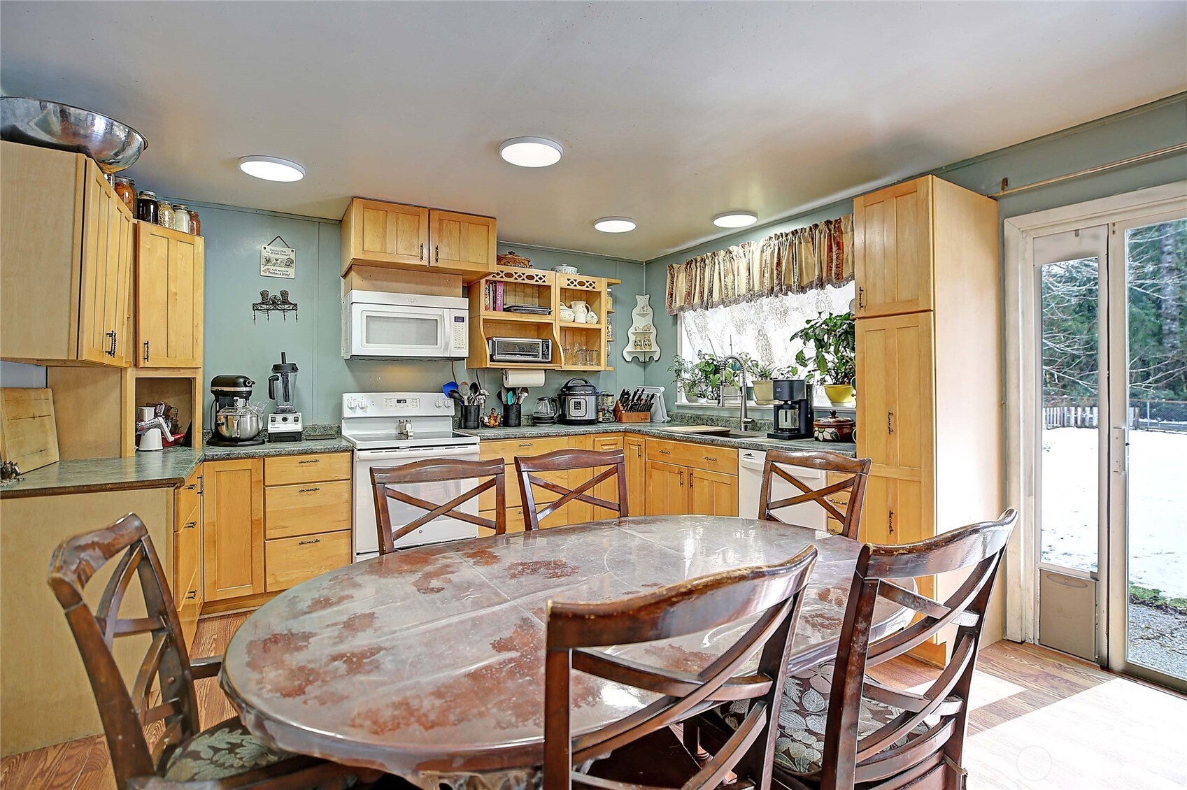 39729 State Rte 530 Northeast Arlington, WA 98223 - Photo 8 of 40 a kitchen with stainless steel appliances granite countertop a stove a sink a dining table and chairs