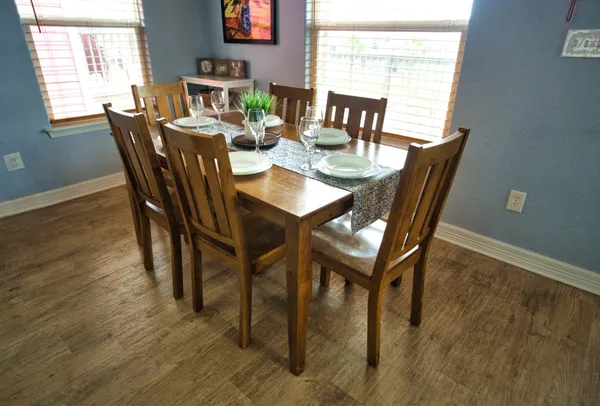 a dining room with furniture and wooden floor