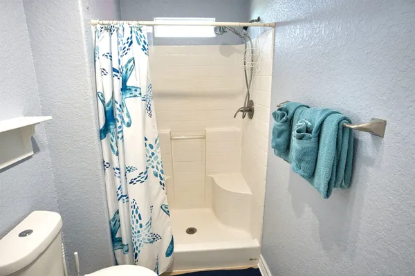 a bathroom with a shower and toilet