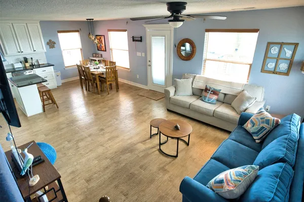 a living room with furniture a rug and a window