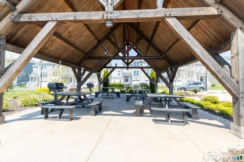 a view of a patio with couches chairs potted plants and a big yard