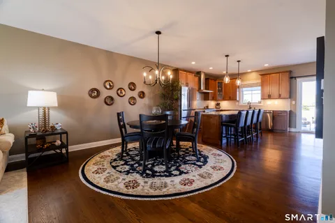 a dining room with furniture wooden floor a chandelier