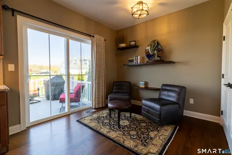 a living room with furniture and a floor to ceiling window