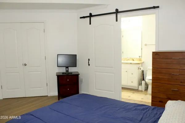 a bedroom with a dresser and a window