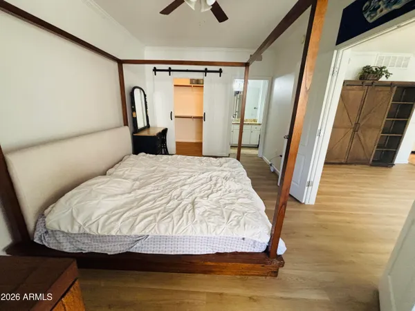 a bedroom with a bed and a mirror