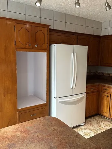 a kitchen with a refrigerator and a microwave