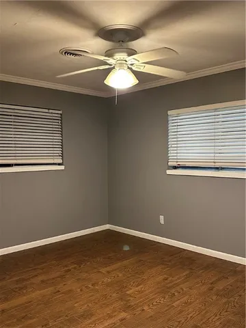 a view of a room with wooden floor and fan